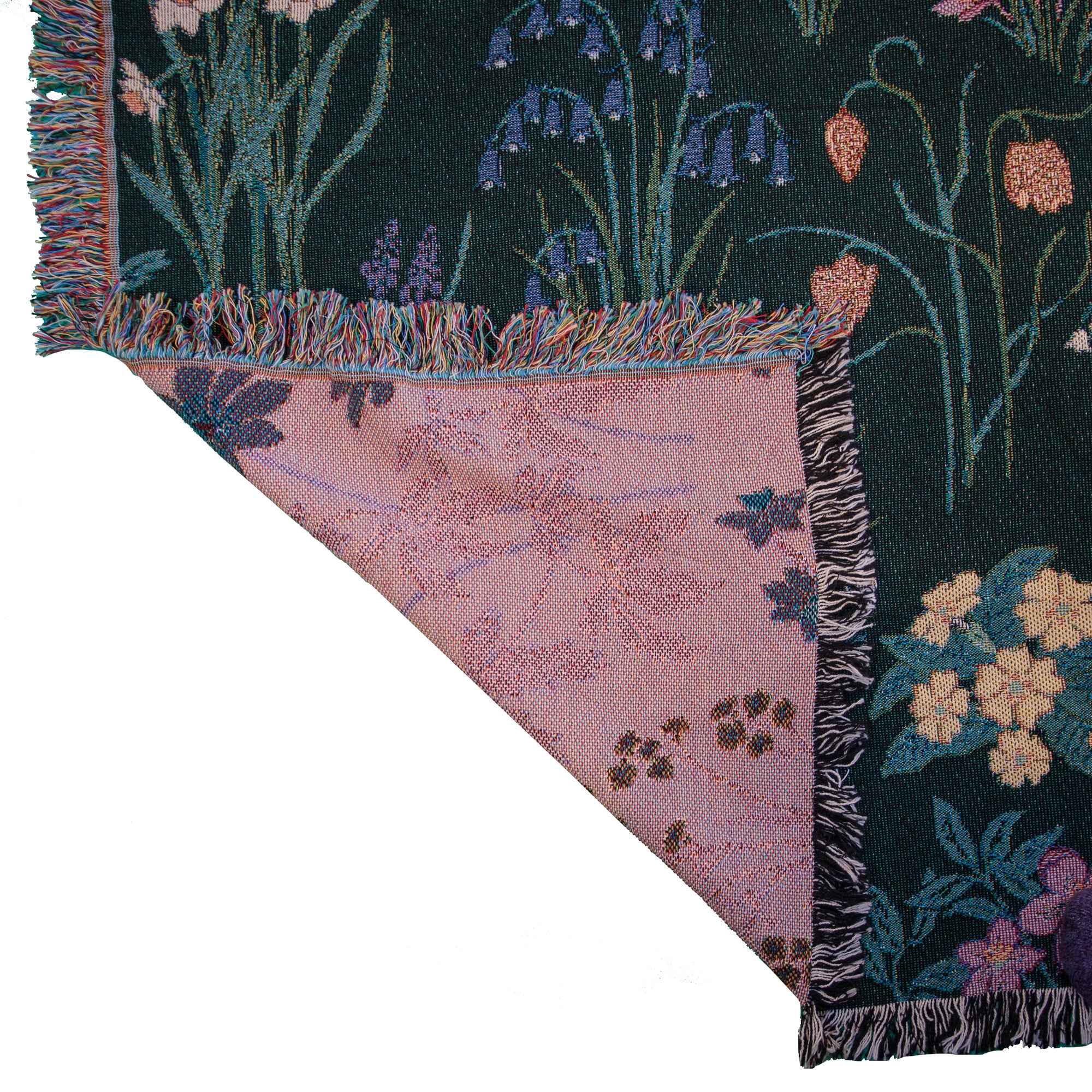 detail of Spring flowers woven blanket in dark green with light coloured fratilleries, primrose and bluebells