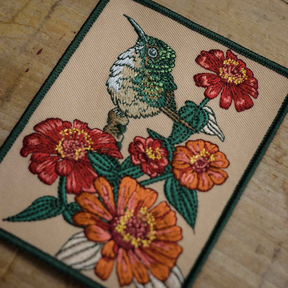 Detail of Hummingbird and Zinnia Embroidered Patch from WildloreFromArcana