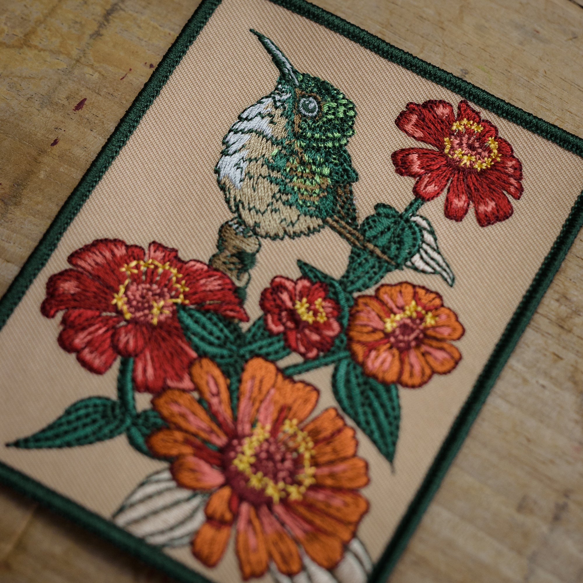 Detail of Hummingbird and Zinnia Embroidered Patch from WildloreFromArcana