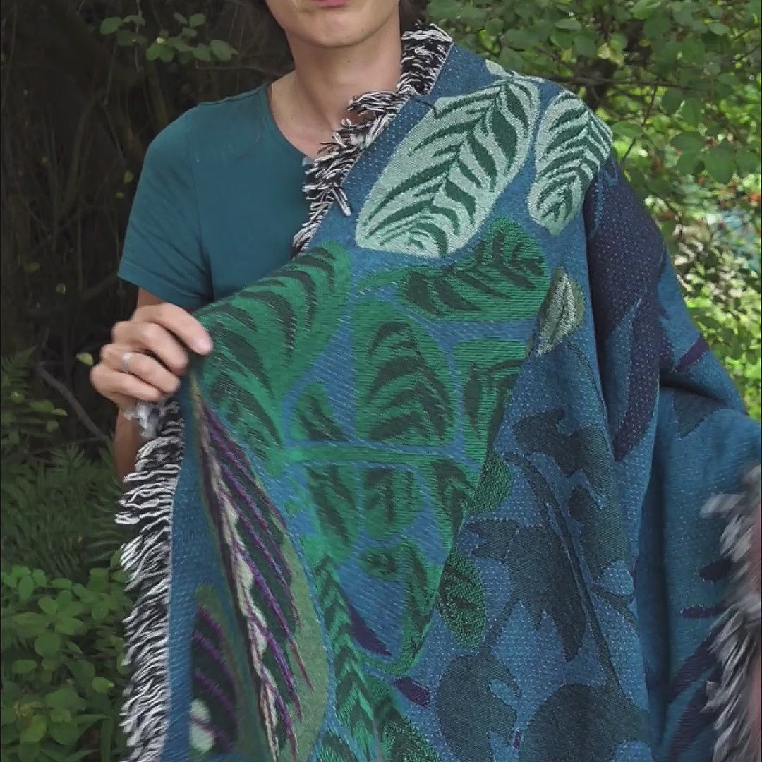 video showing blue and green woven blanket featuring houseplants