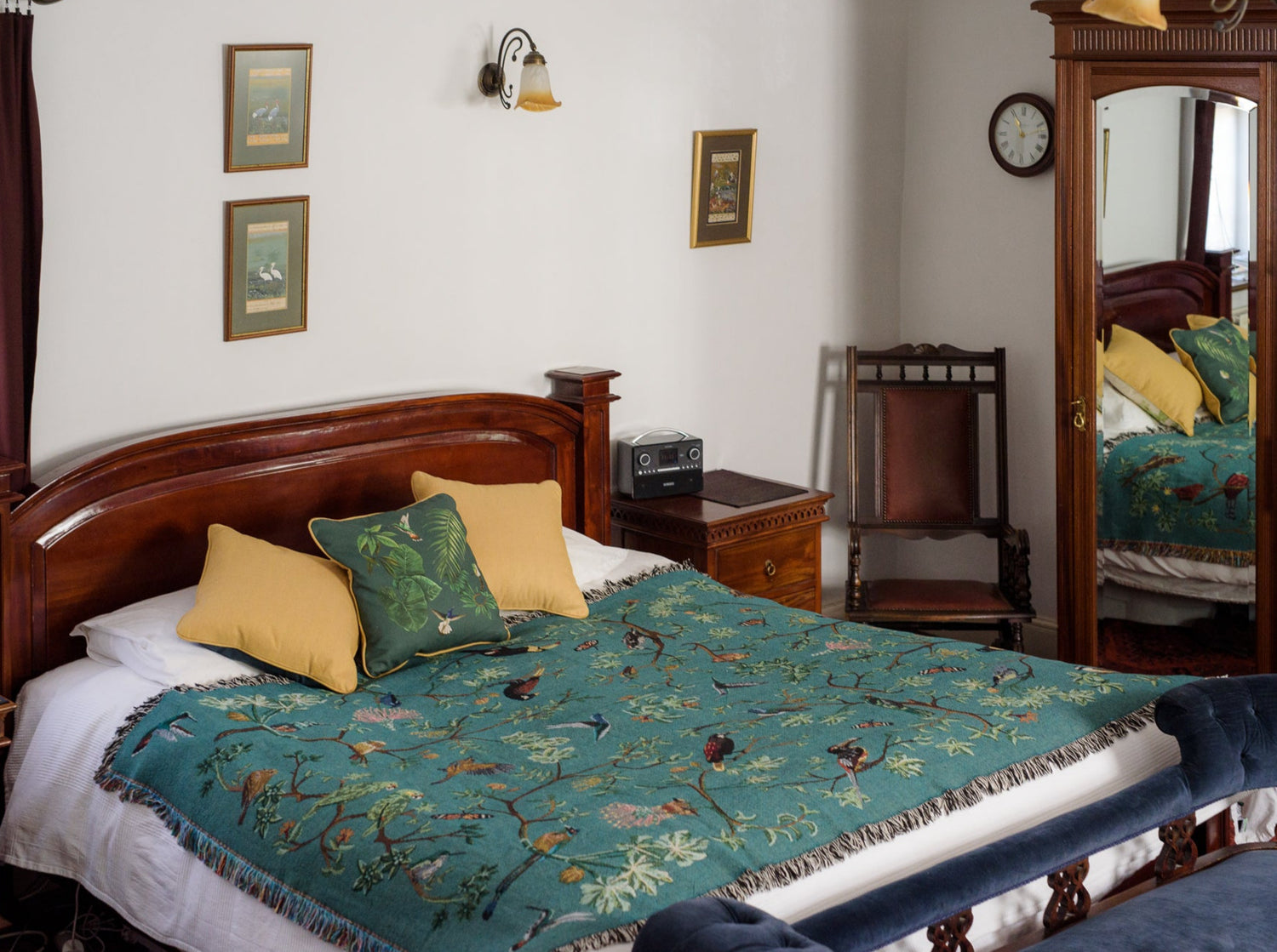 tropical bird woven throw blanket acorss a super kingsized bed