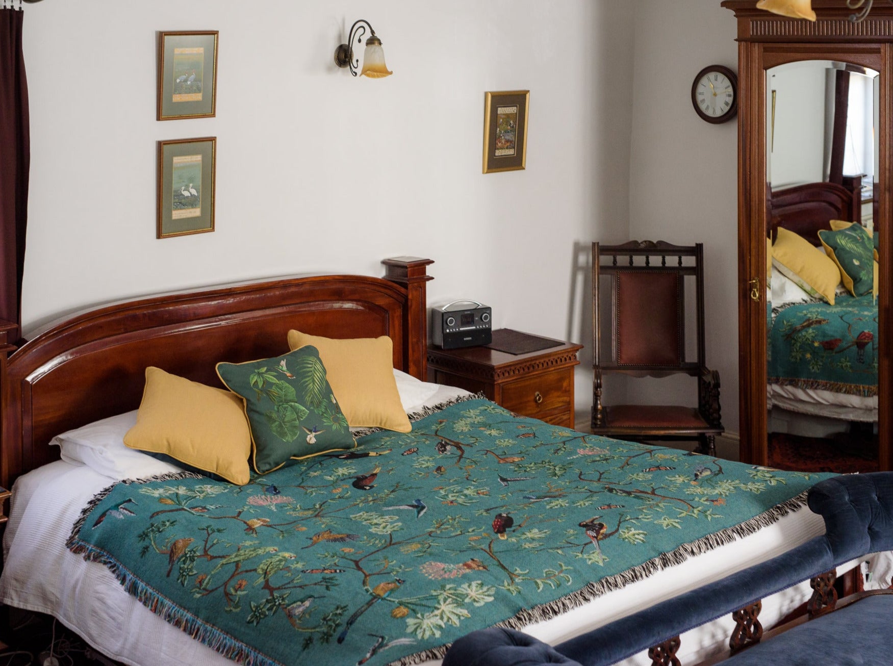 tropical bird woven throw blanket acorss a super kingsized bed