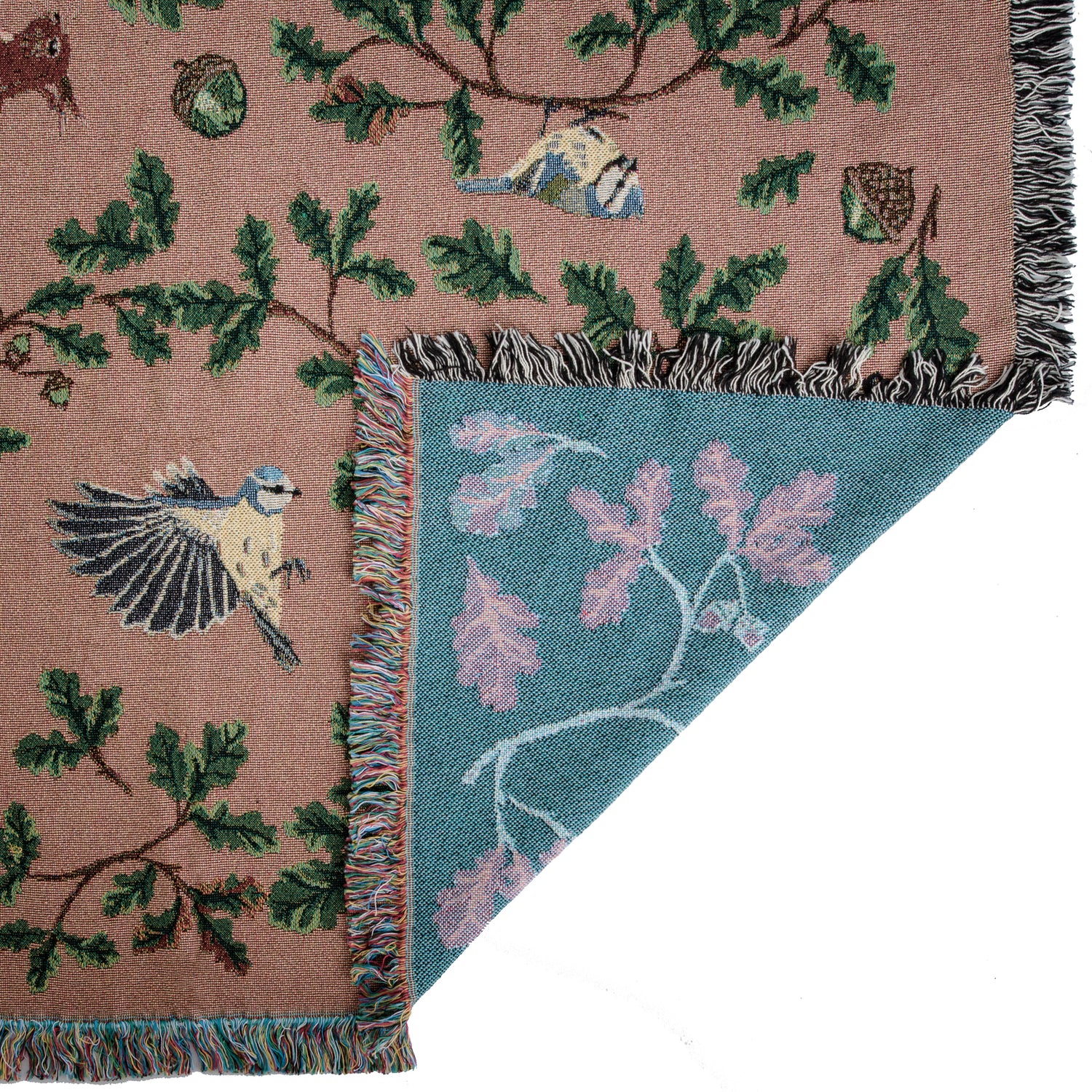 russet coloured woven blanket with teal reverse featuring birds, squirrels and oak